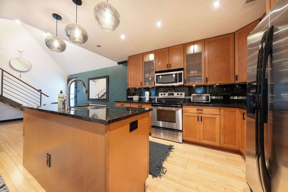 Spacious modern kitchen with sleek appliances and a stylish island, perfect for cooking and entertaining.