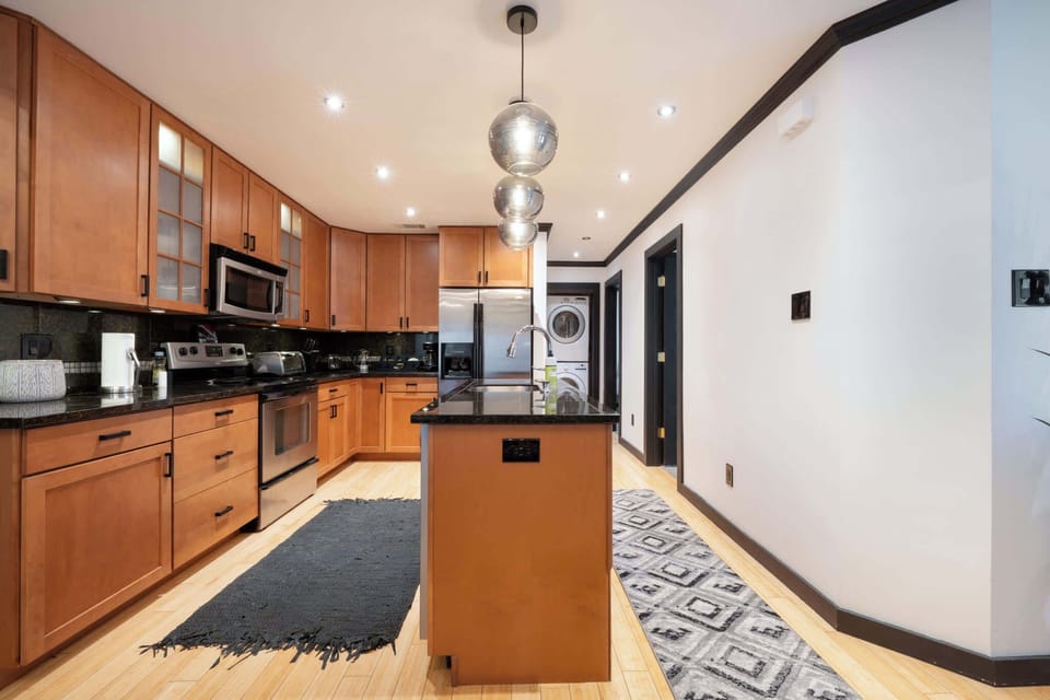 Modern kitchen with sleek appliances and ample counter space, perfect for culinary enthusiasts.