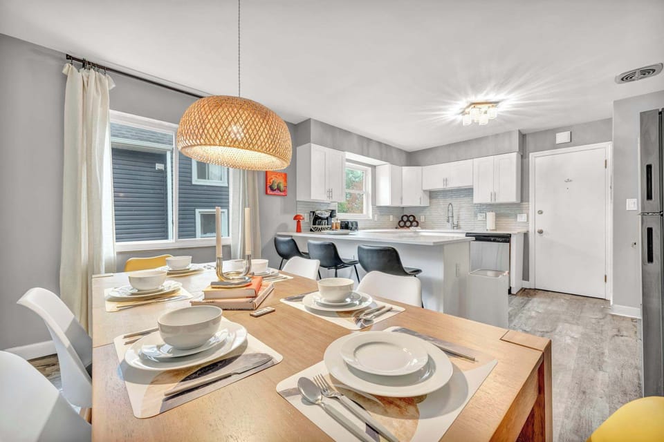 Dine open-concept, steps from the kitchen under twin hanging lights