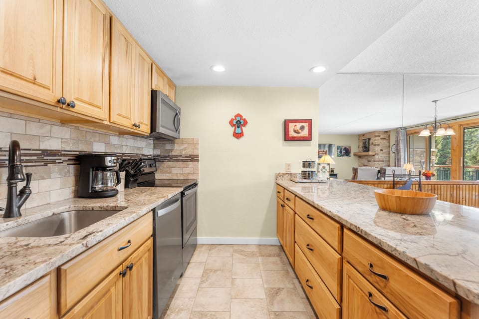 Your fully equipped kitchen features granite countertops, modern appliances, and plenty of space to prepare delicious meals during your stay.
