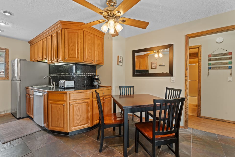 You'll love preparing meals in your fully equipped kitchen, complete with oak cabinetry and modern appliances. Gather at the cozy dining table with seating for four and enjoy home-cooked favorites together.