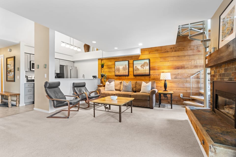 Unwind in your inviting living space, where warm wood accents and plush seating create a cozy mountain retreat. Perfect for relaxing after a day of adventure.