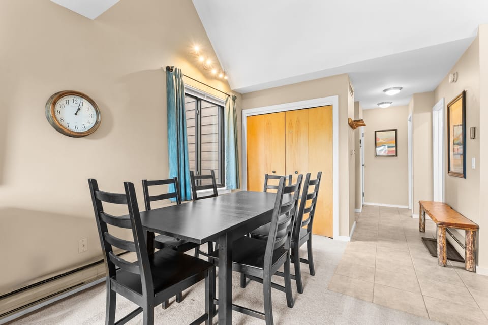 Gather around the inviting dining table for memorable meals and game nights with your group. The space flows seamlessly into the hallway, creating an open and welcoming atmosphere for your stay.