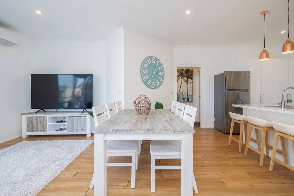 Gather around the spacious dining table for shared meals, or pull up a seat at the breakfast bar while chatting with the cook in the bright, open-plan kitchen.