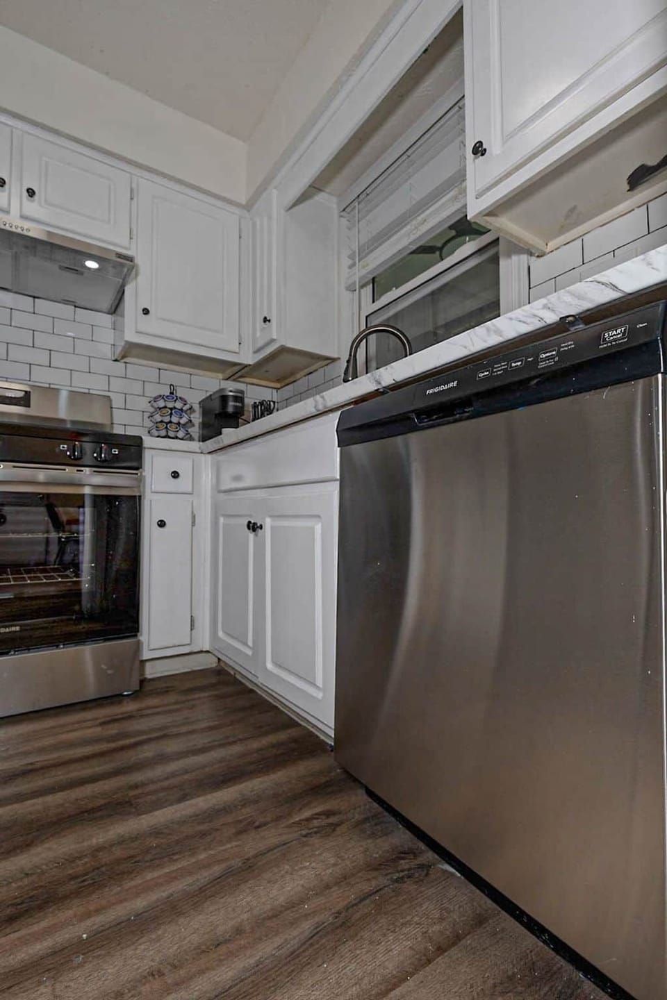 Stainless appliances and freshly renovated cabinetry throughout the kitchen