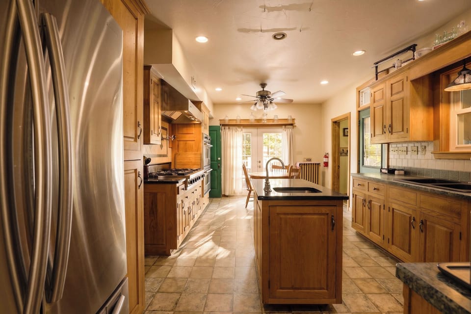 The island in the center of the kitchen includes an additional sink. 