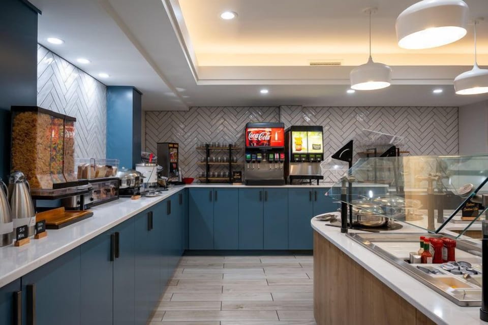 Coffee and grab-and-go snacks stock this buffet counter, part of the complimentary breakfast each morning.