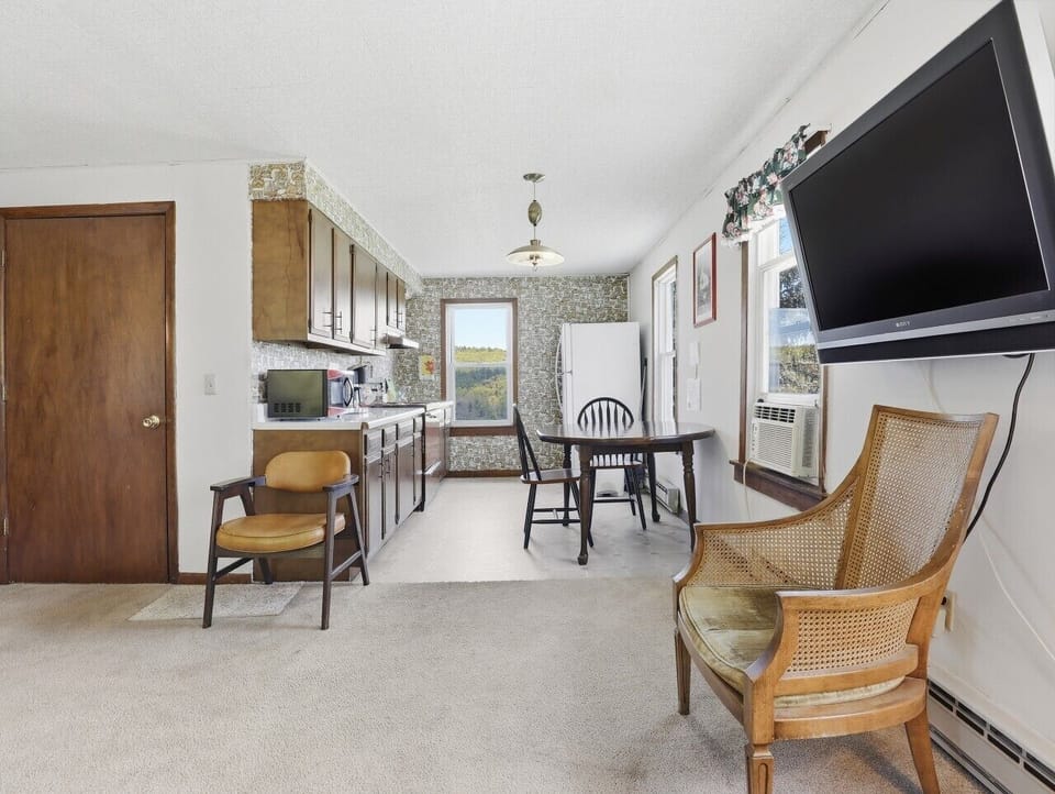 Dining Area | Open Kitchen | TV & Forest Views