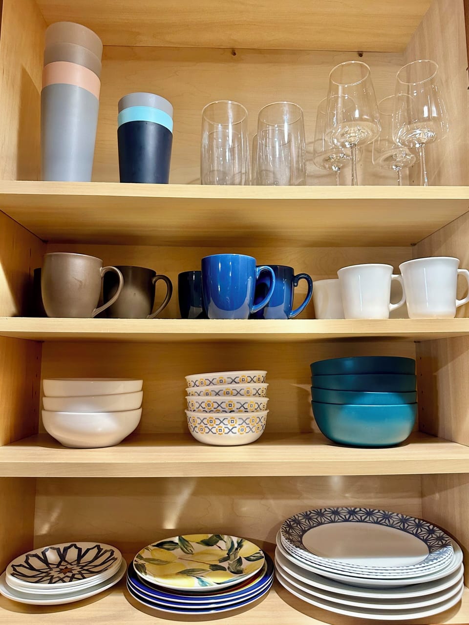 Plenty of dishes, bowls, mugs, and wine glasses for everyone.