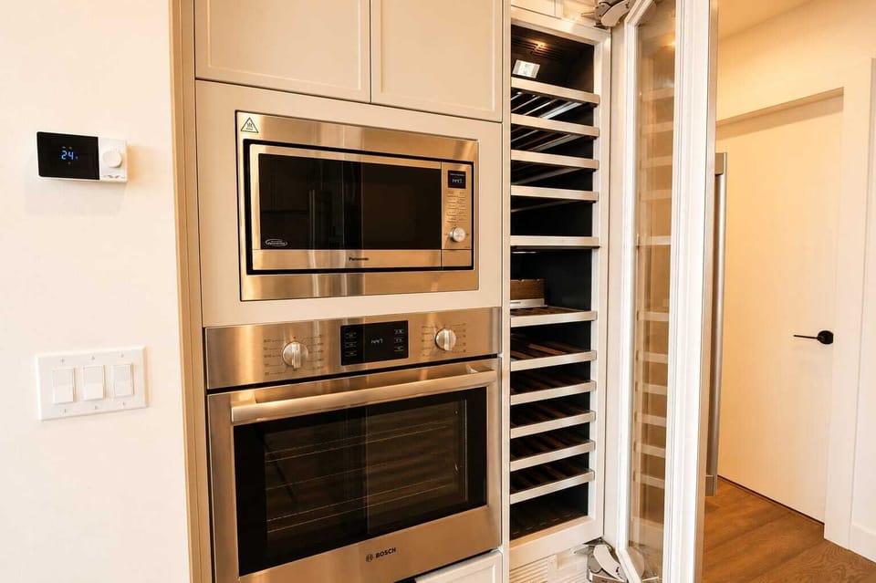 Modern built-in oven, microwave, and full-height wine fridge