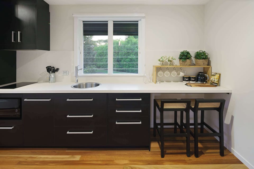 Modern kitchen includes a full sized fridge