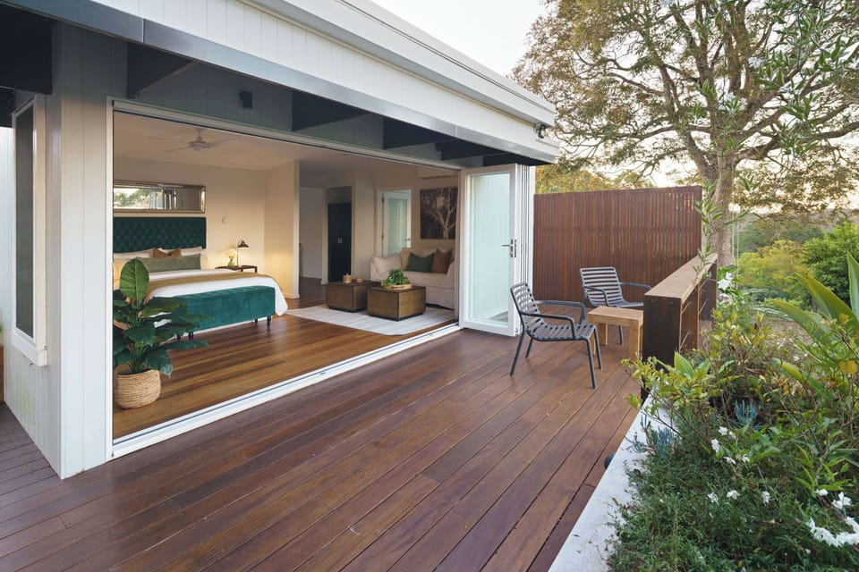 Floor to ceiling bifold doors frame the picturesque outlook