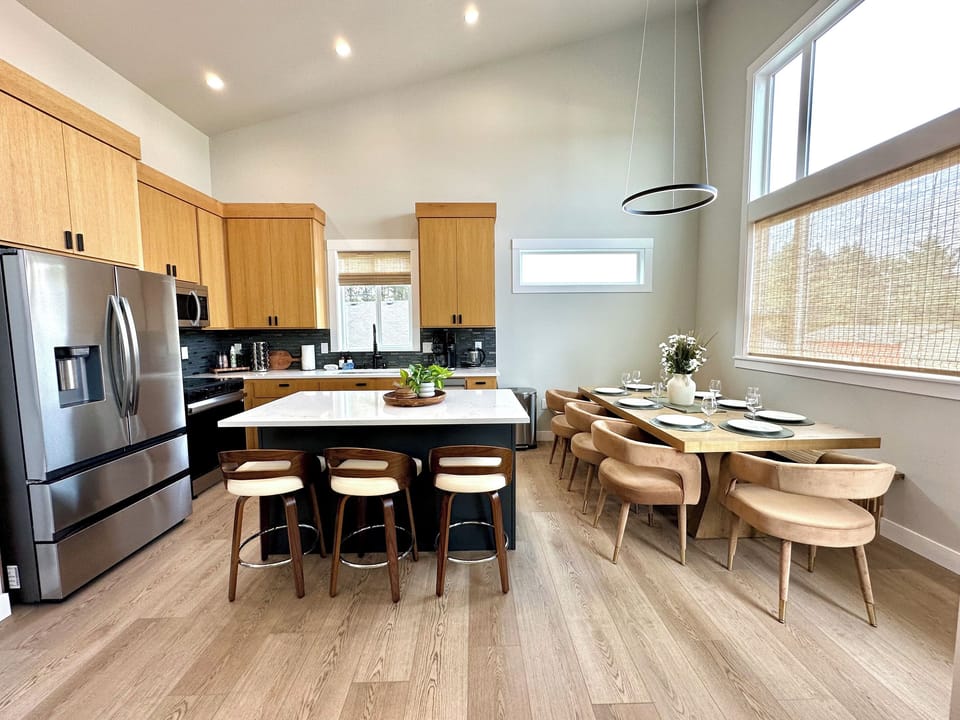 Cook for the whole crew without anyone stepping on toes — quartz island seating for three, and a table already set for eight so the first night's dinner starts the second you unpack.