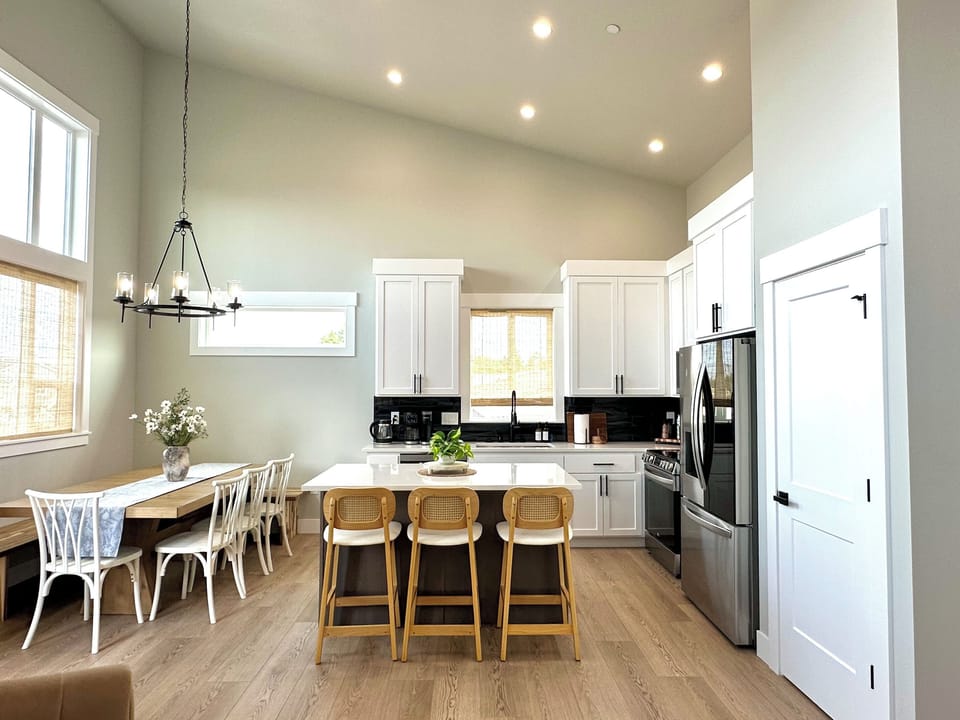 Cook Side B's dinner around the island with three stools already pulled up — pots, pans, and every gadget you'd actually reach for are already here.