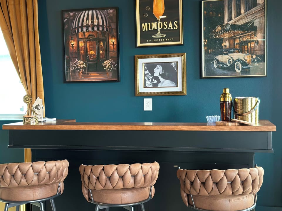Shaker, ice bucket and a gallery wall of vintage prints — the Speak Easy is set for happy hour downstairs while the main level stays calm.