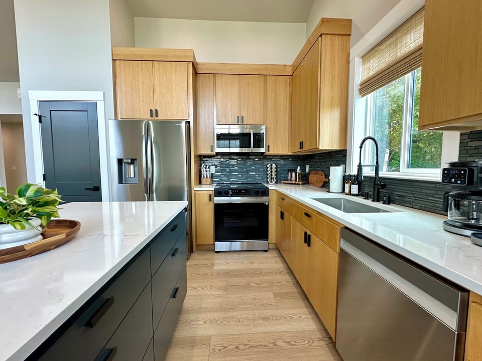 The kitchen is fully stocked: quartz counters and full-size stainless appliances. Bring your clothes and your groceries; we have the rest.