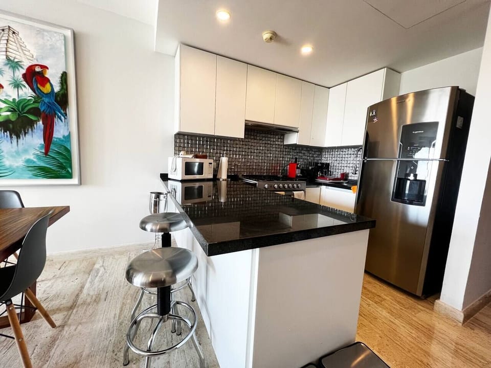 Fully equipped kitchen boasts modern appliances and ample counter space, perfect for preparing delicious meals during your stay. 