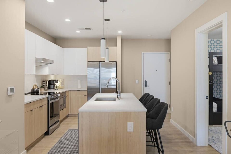 Fully equipped kitchen with modern appliances and ample counter space perfect for cooking a meal. Large island including seating for 4.