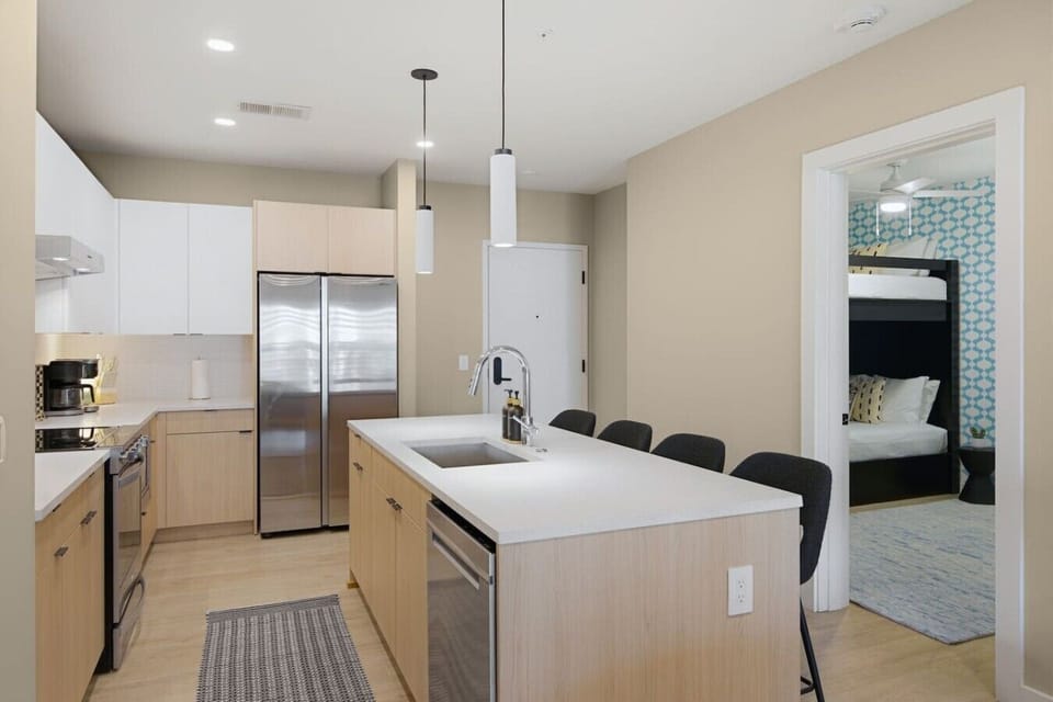 Fully equipped kitchen with modern appliances and ample counter space perfect for cooking a meal. Large island including seating for 4.