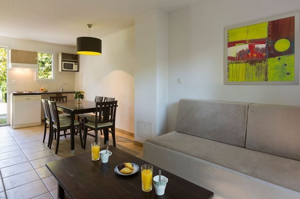The open-plan layout connects the kitchen, dining, and living areas naturally — a practical and sociable arrangement for five guests.