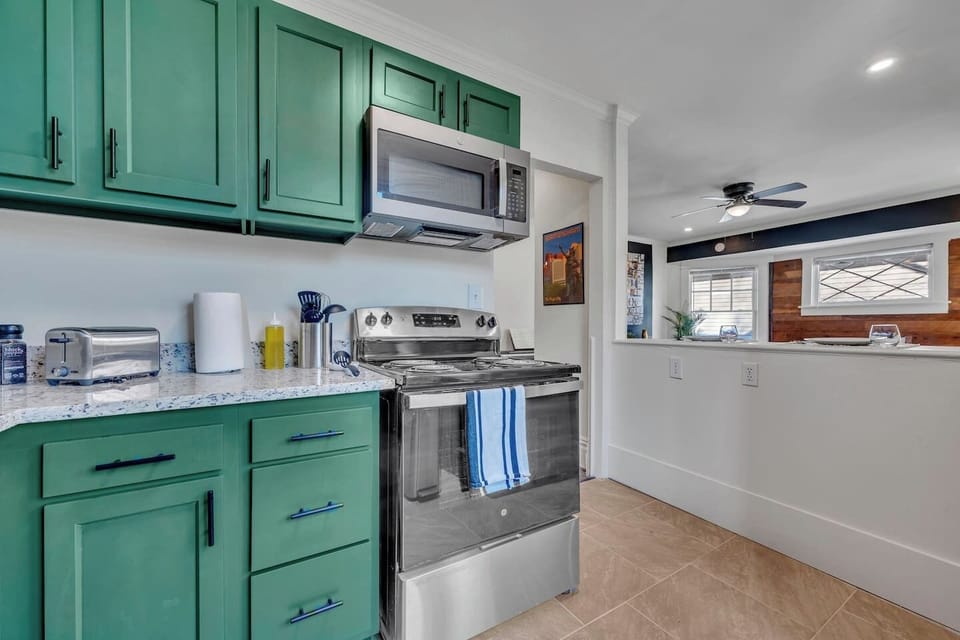 Whip up breakfast or your favorite homemade meal in this fully equipped kitchen, featuring full-size stainless steel appliances, generous prep space, and a bright, open layout overlooking the living area.