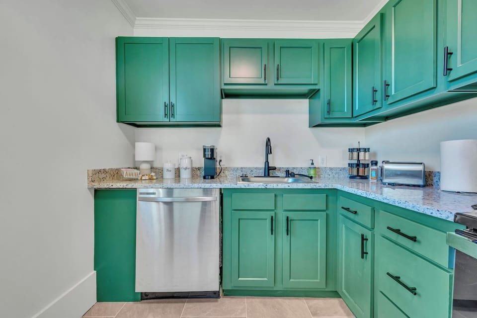 Beautiful emerald cabinetry, granite countertops, stainless steel, and everything you need to cook with confidence make this kitchen as functional as it is stylish.