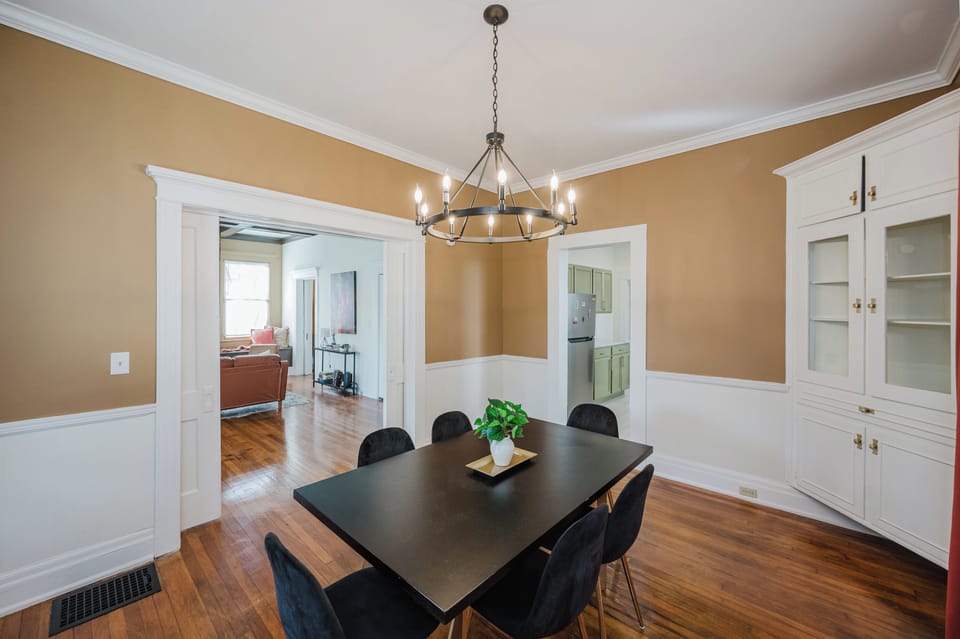 Large windows brighten the space by day, while room-darkening shades offer added privacy when needed. With timeless architectural details and comfortable seating, every meal feels a little more special.