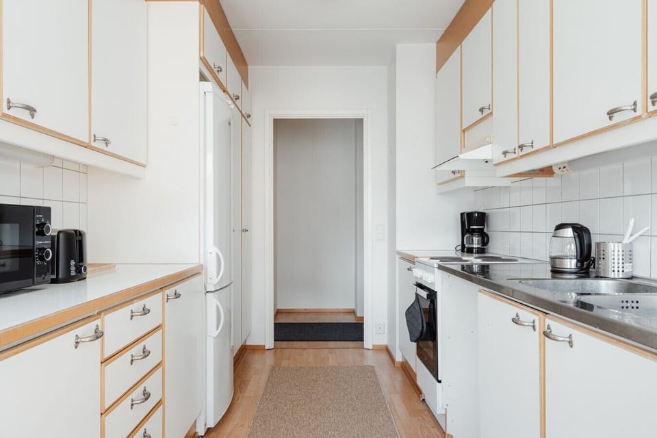 Well-equipped kitchen with a coffee maker, kettle and generous counter space.