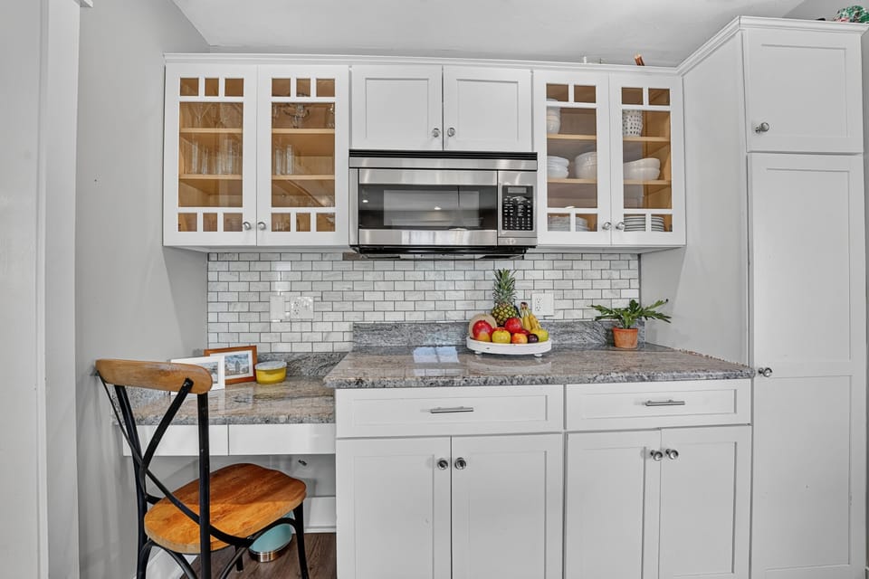 Coffee bar and beverage station with built-in microwave and storage.