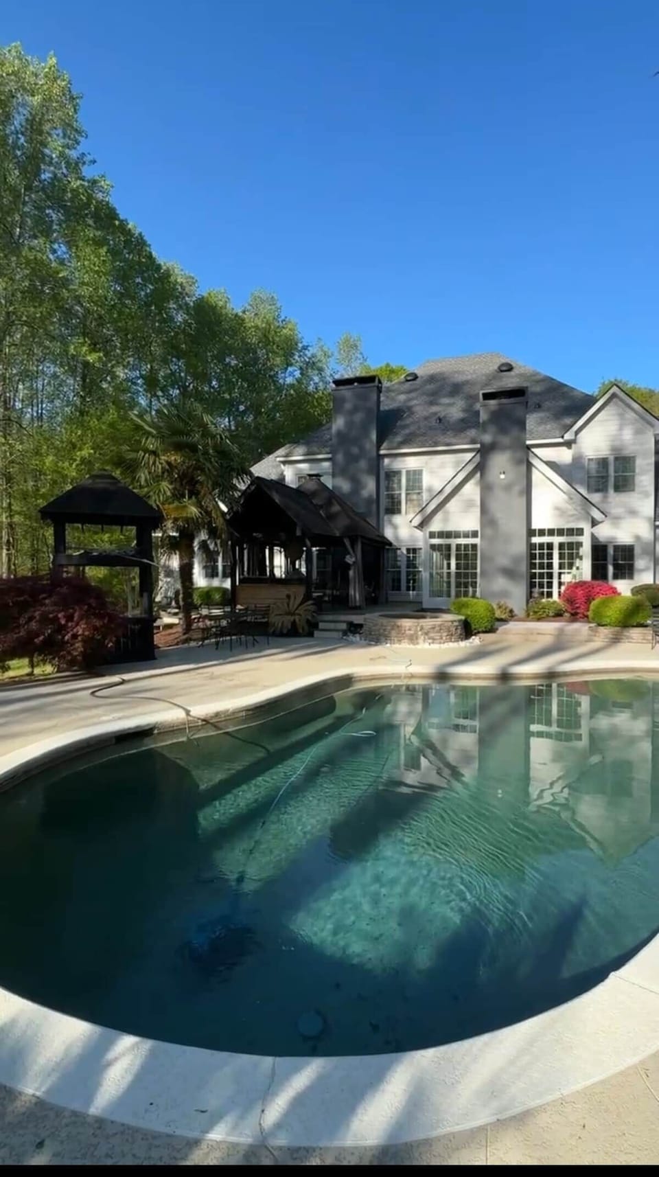 Shared pool beside the estate and outdoor gathering area at Chef’s Château