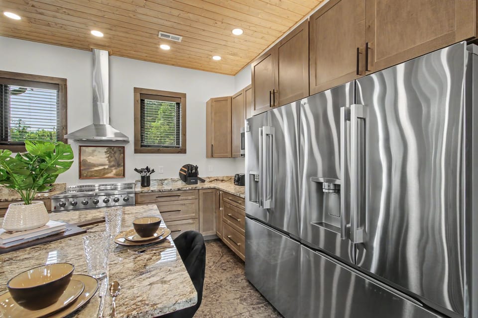 🍳 The chef's kitchen features a spacious island, coffee bar, and seating that keeps everyone connected while meals come together.