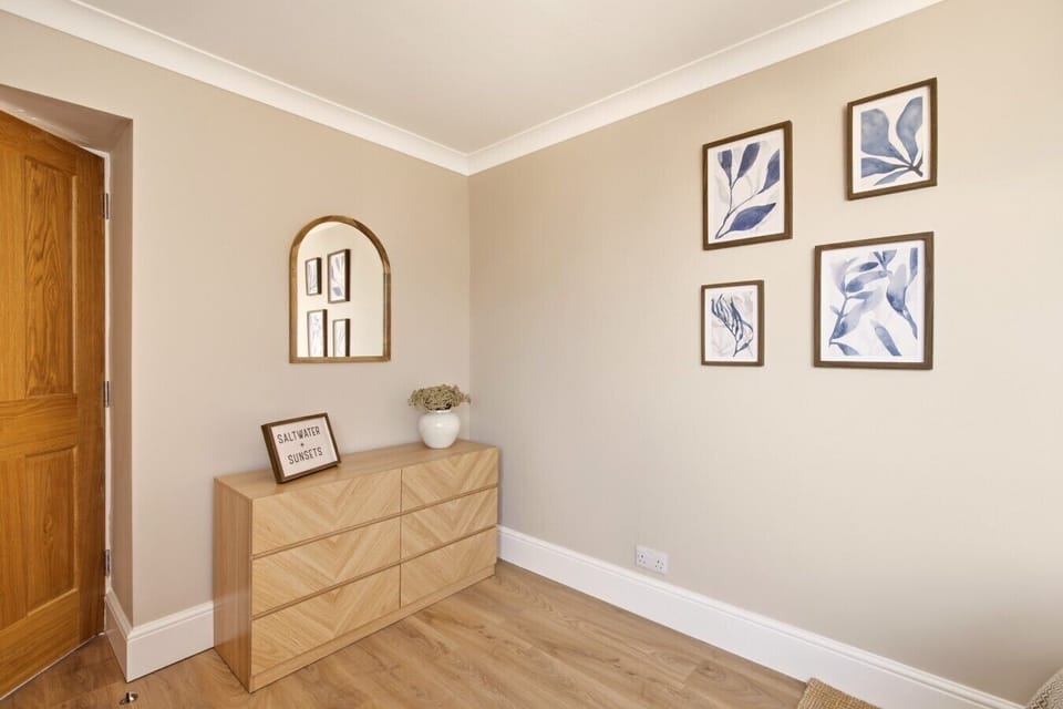 Bedroom with double bed, clothes stand and soft neutral décor.
