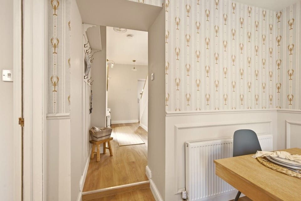 Bedroom with double bed, clothes stand and soft neutral décor.