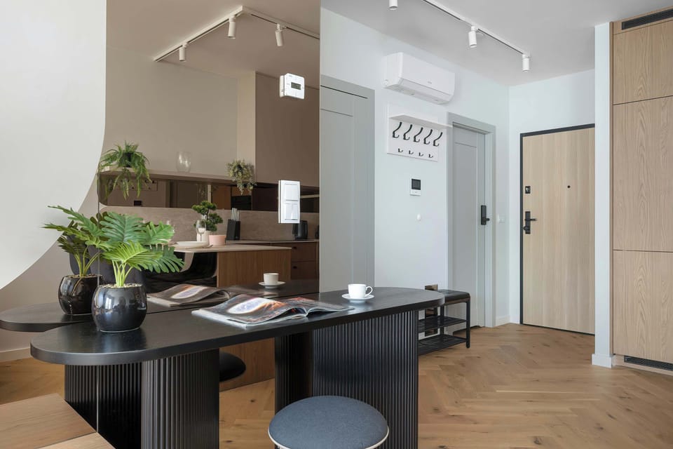 The living room has a modern look and comfortable furniture.