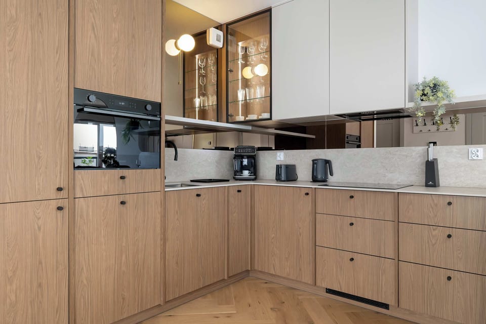 The sleek design of the kitchenette blending seamlessly with the living area.