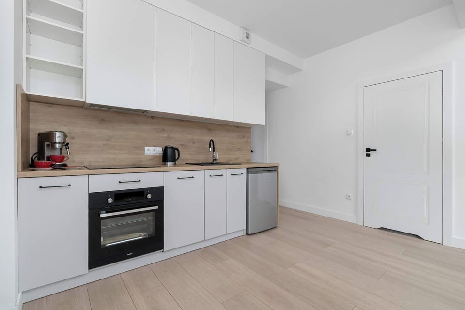 The sleek design of the kitchenette blending seamlessly with the living area.