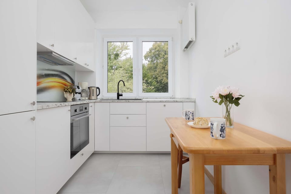 The kitchen's sleek design includes all necessary cookware and utensils.