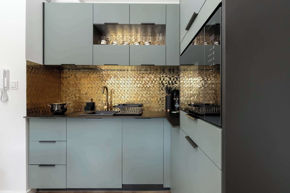 The sleek design of the kitchenette blending seamlessly with the living area.