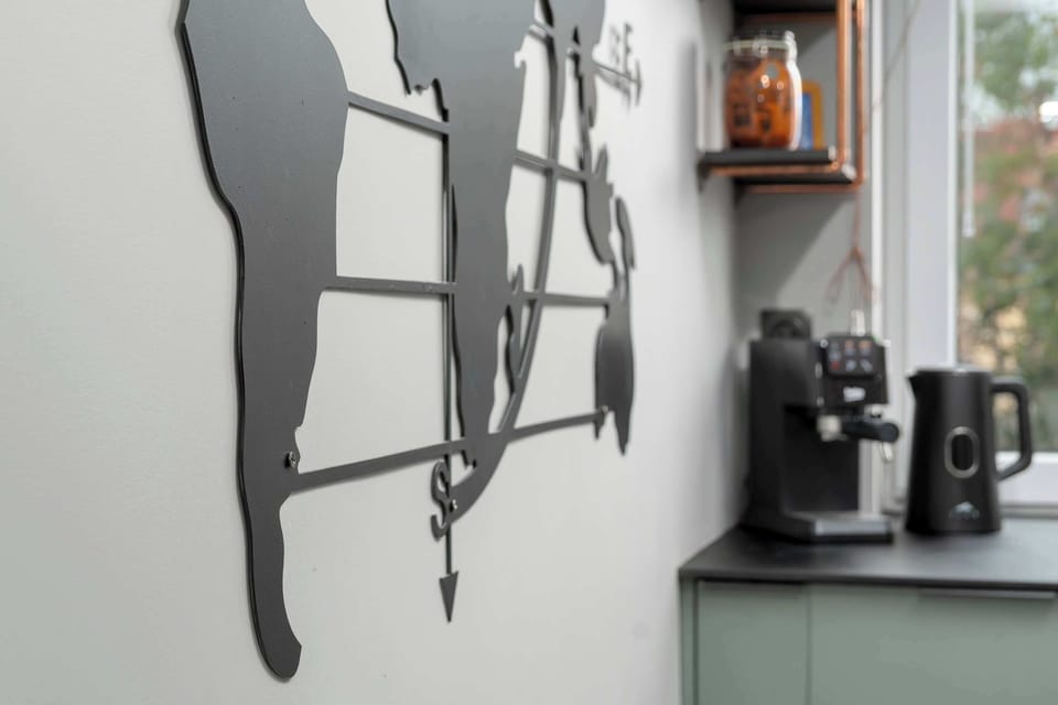 The kitchen's sleek design includes all necessary cookware and utensils.