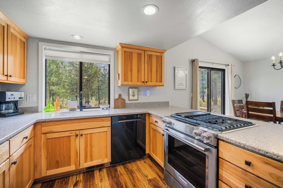 Step into your fully equipped kitchen with a gas range and everything you need to prepare memorable meals, all while enjoying peaceful natural views through the windows.