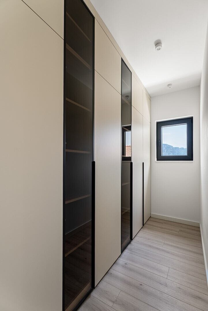 A spacious walk-in wardrobe offering ample storage and an elegant, organized space for your clothing and accessories