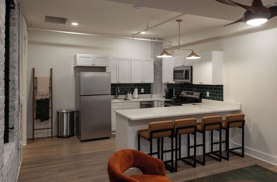 Modern kitchen with breakfast bar seating for four and sleek finishes