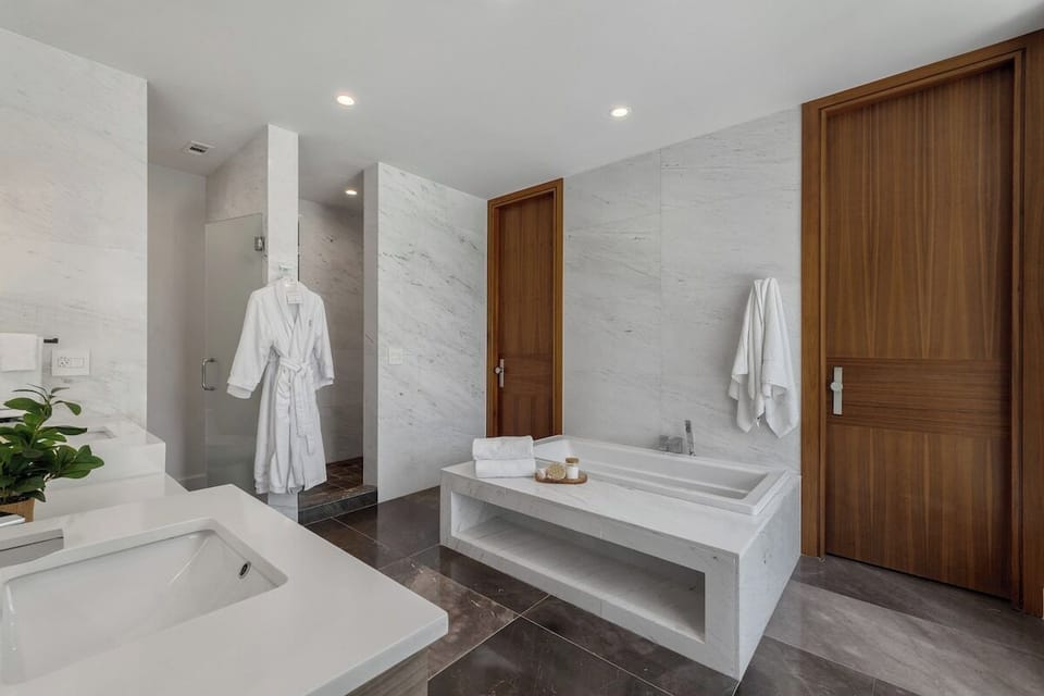Deep soaking tub, walk-in shower, and spa robe await after adventures.