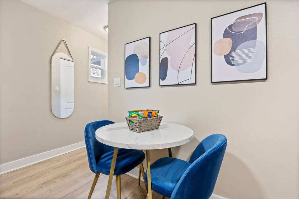 This dining area features a small table and two comfortable chairs, ideal for enjoying meals or a morning coffee.