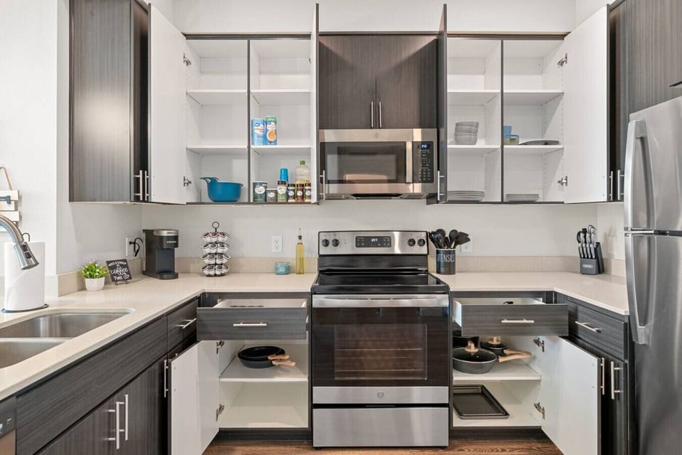 Fully stocked kitchen with stainless steel appliances, a coffee station, and cooking supplies for preparing home-cooked meals.