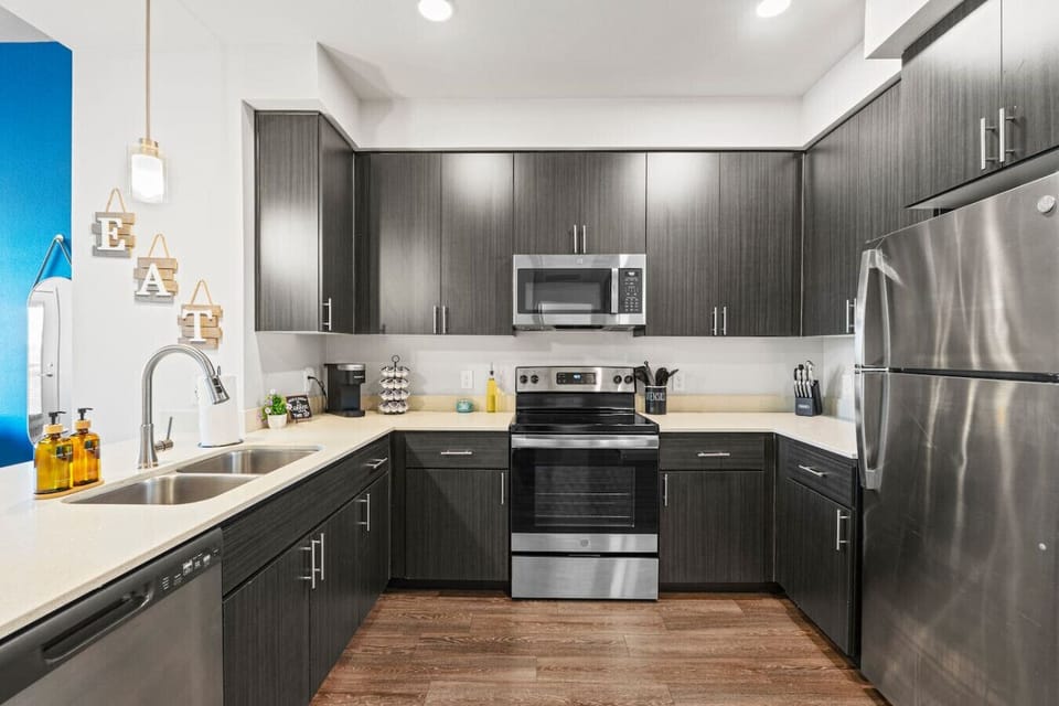 Prepare delicious meals with ease in this fully equipped kitchen, featuring stainless steel appliances, a convenient coffee station, and all the necessary cooking supplies.