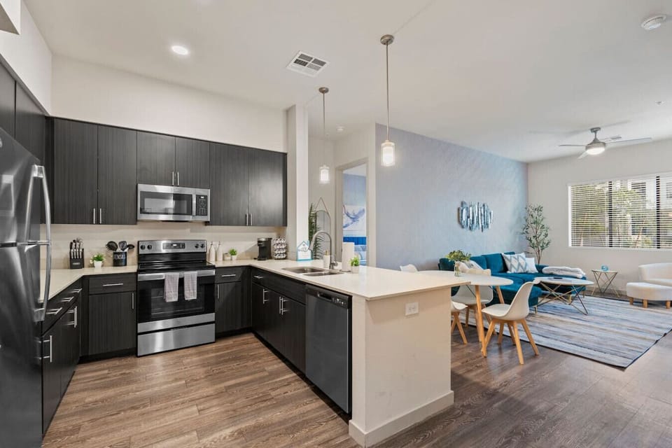 This modern kitchen features sleek cabinetry, stainless steel appliances, and an open layout that`s perfect for entertaining.