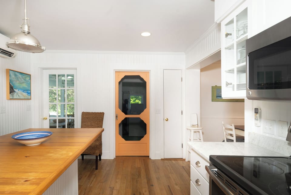 Your bright kitchen and dining space flows effortlessly, featuring gleaming countertops, modern appliances, and a welcoming island perfect for morning coffee or evening meal prep.
