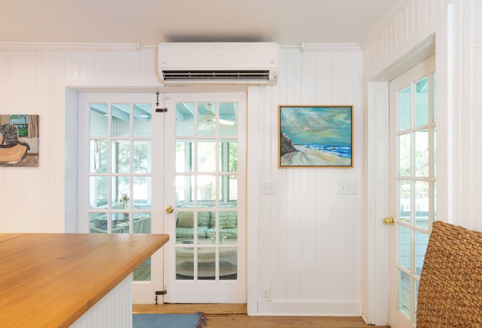 Step into your bright, coastal-inspired retreat where natural light pours through French doors and art reflects the seaside serenity. Stay cool and comfortable with efficient climate control.