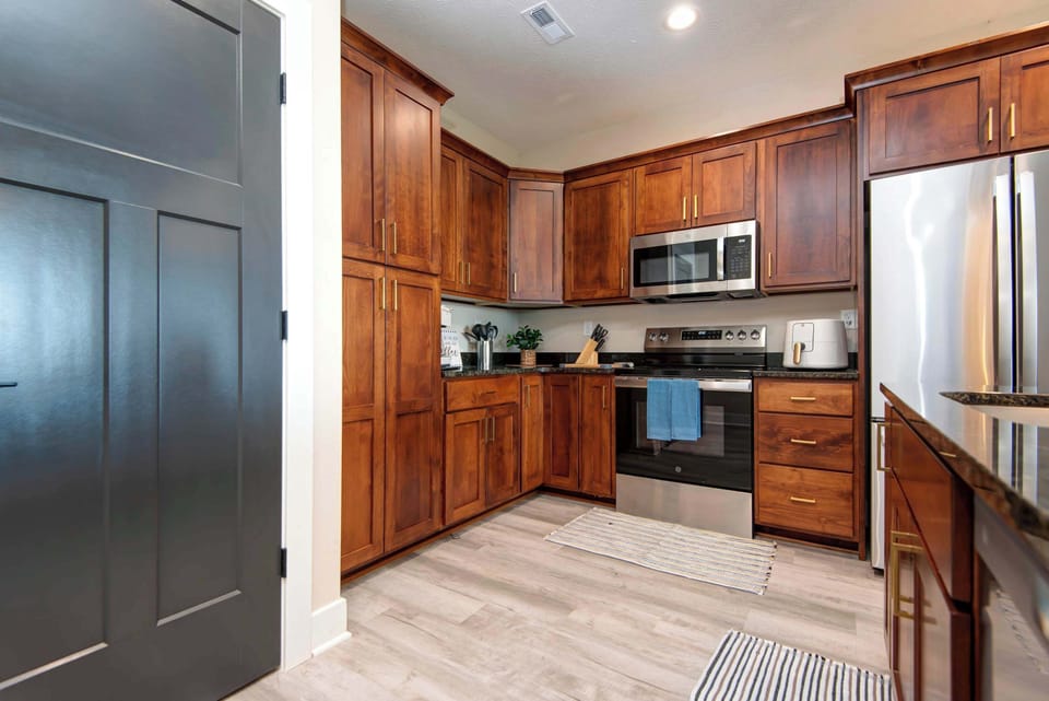 Cook with ease in the fully equipped kitchen featuring stainless steel appliances, ample counter space, and everything needed for family meals and entertaining.